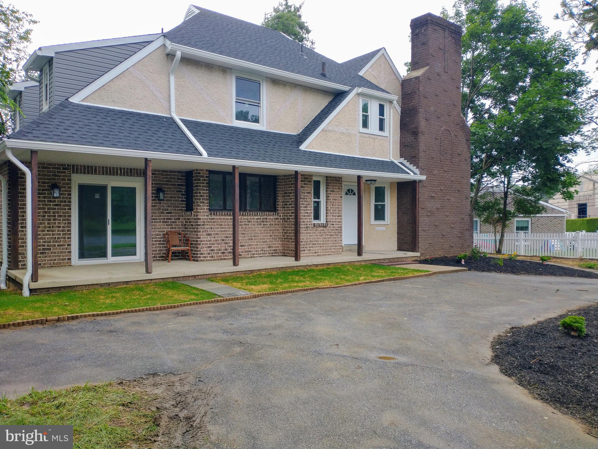 512 Mifflin Boulevard Reading, PA 19607 - Photo 4 of 57 a front view of a house with a yard and garage