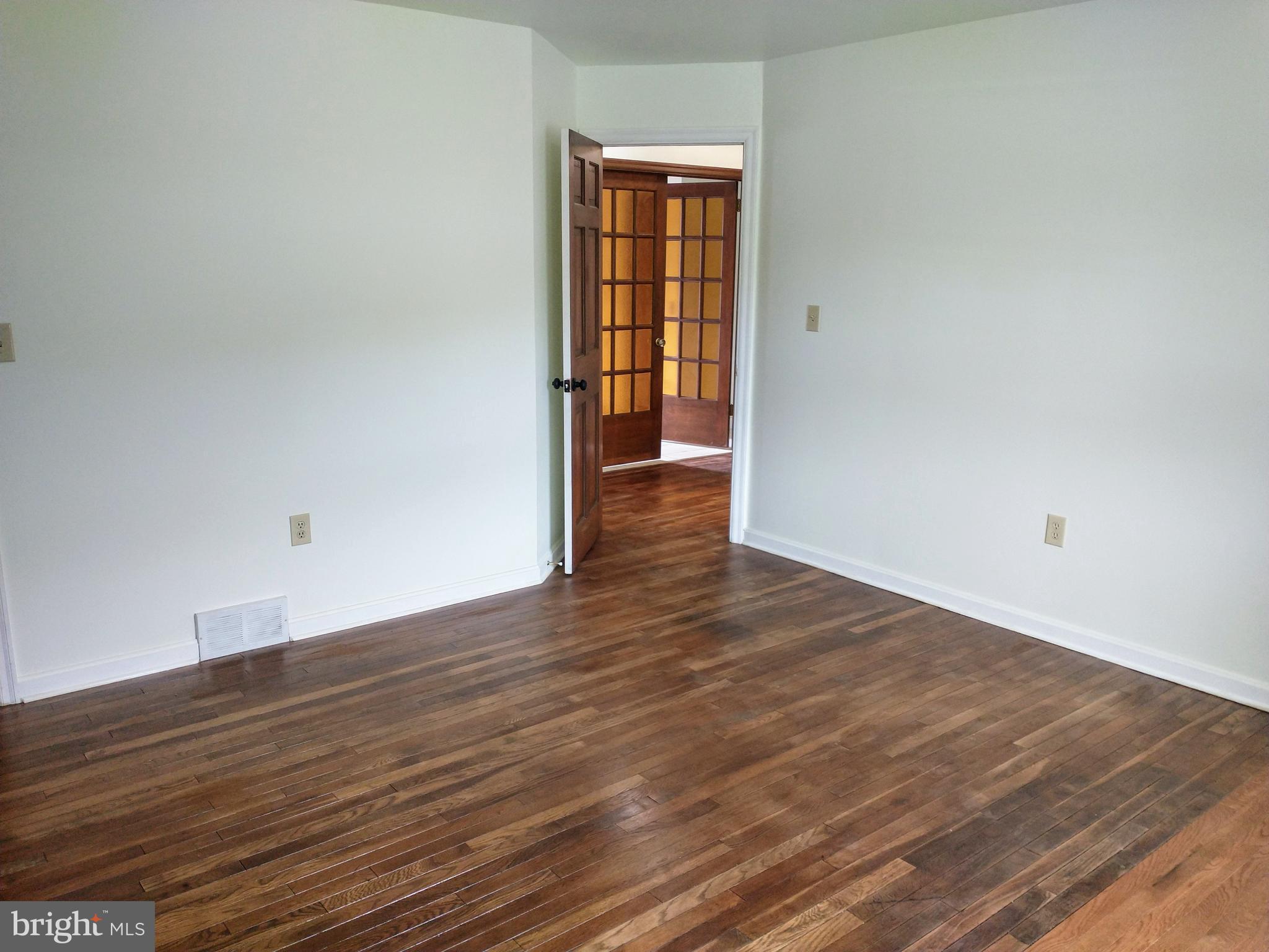 512 Mifflin Boulevard Reading, PA 19607 - Photo 41 of 57 a view of an empty room with wooden floor and a window
