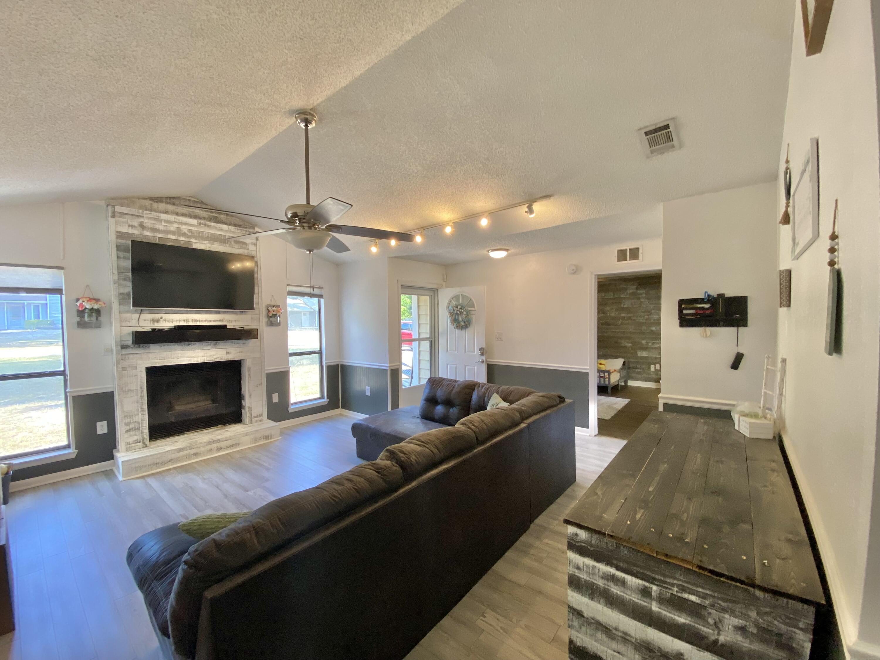 309 Springwood Circle Crestview, FL 32536 - Photo 11 of 44 a living room with furniture and a fireplace