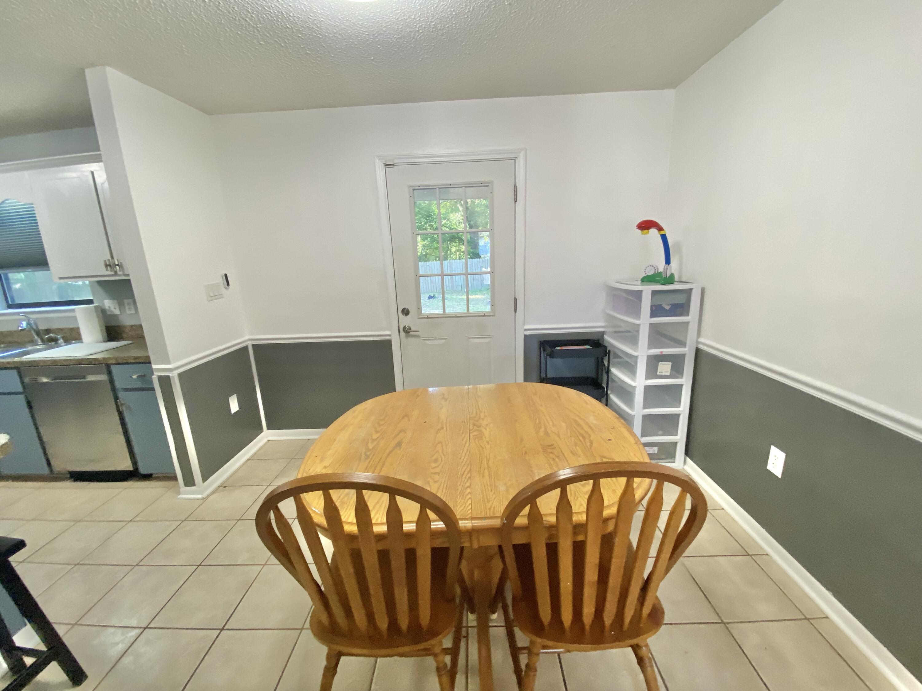 309 Springwood Circle Crestview, FL 32536 - Photo 13 of 44 a dining room with furniture and window