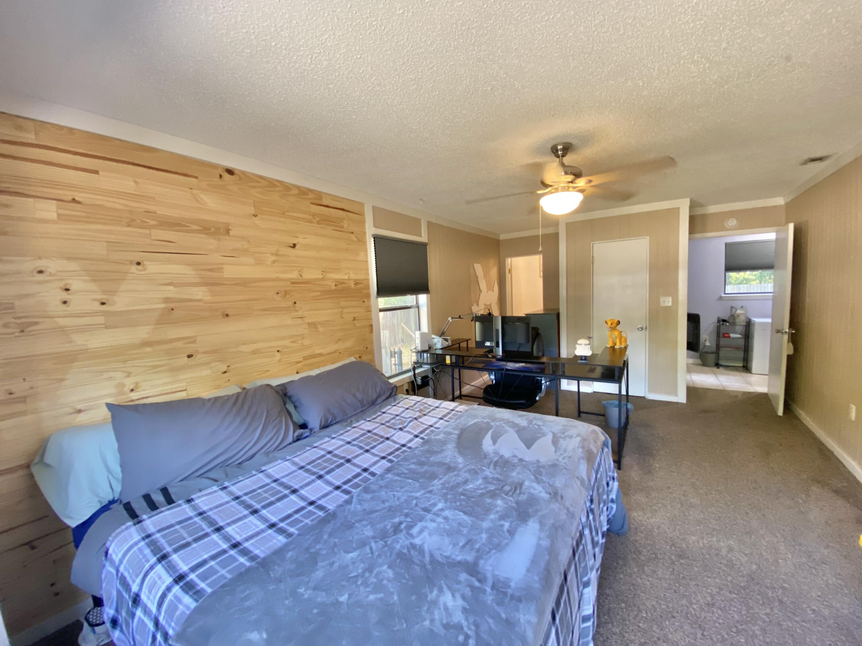 309 Springwood Circle Crestview, FL 32536 - Photo 20 of 44 a large bedroom with a bed a table and chair