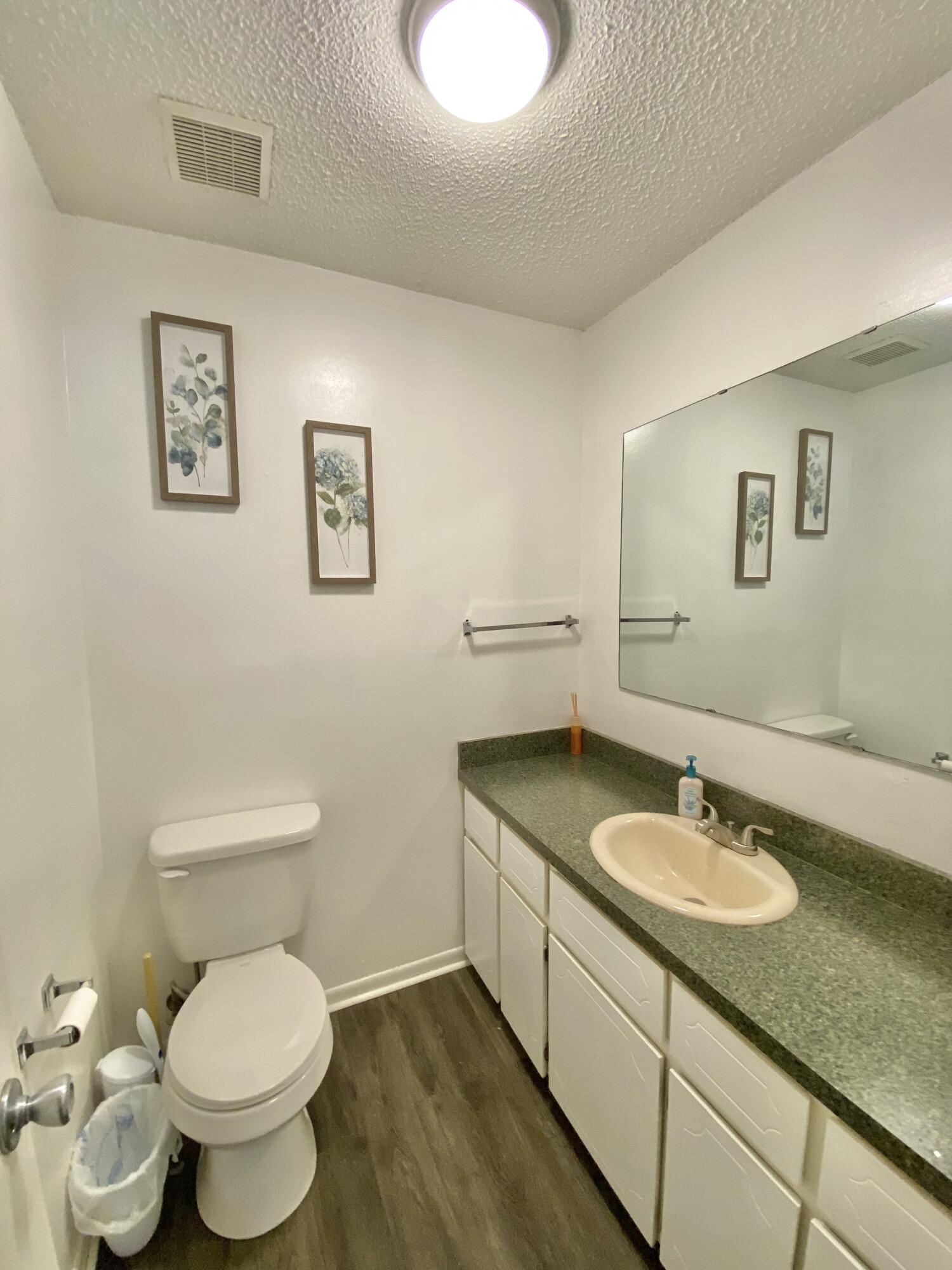 309 Springwood Circle Crestview, FL 32536 - Photo 22 of 44 a bathroom with a granite countertop toilet sink and mirror