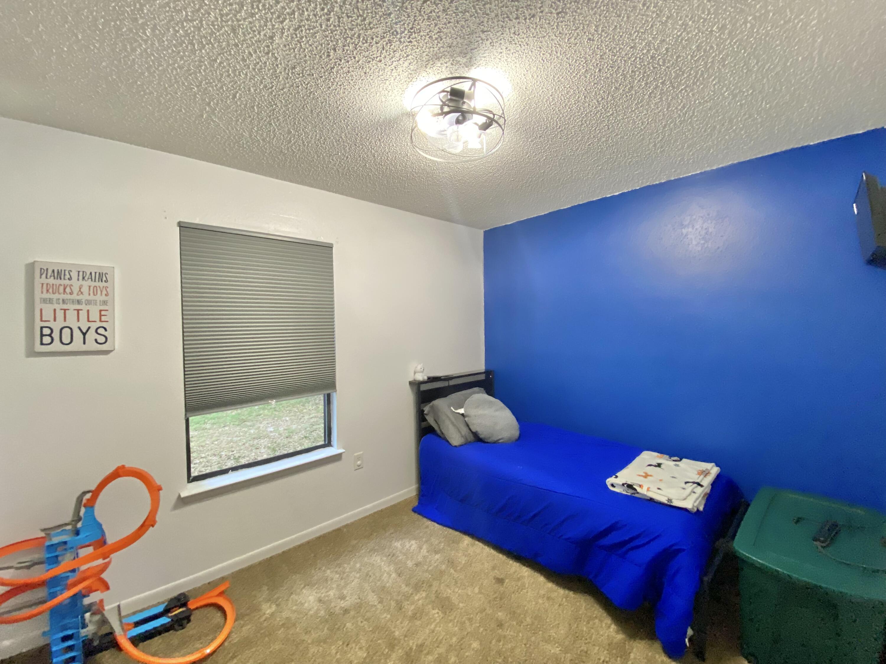309 Springwood Circle Crestview, FL 32536 - Photo 33 of 44 a room with toys and wooden floor