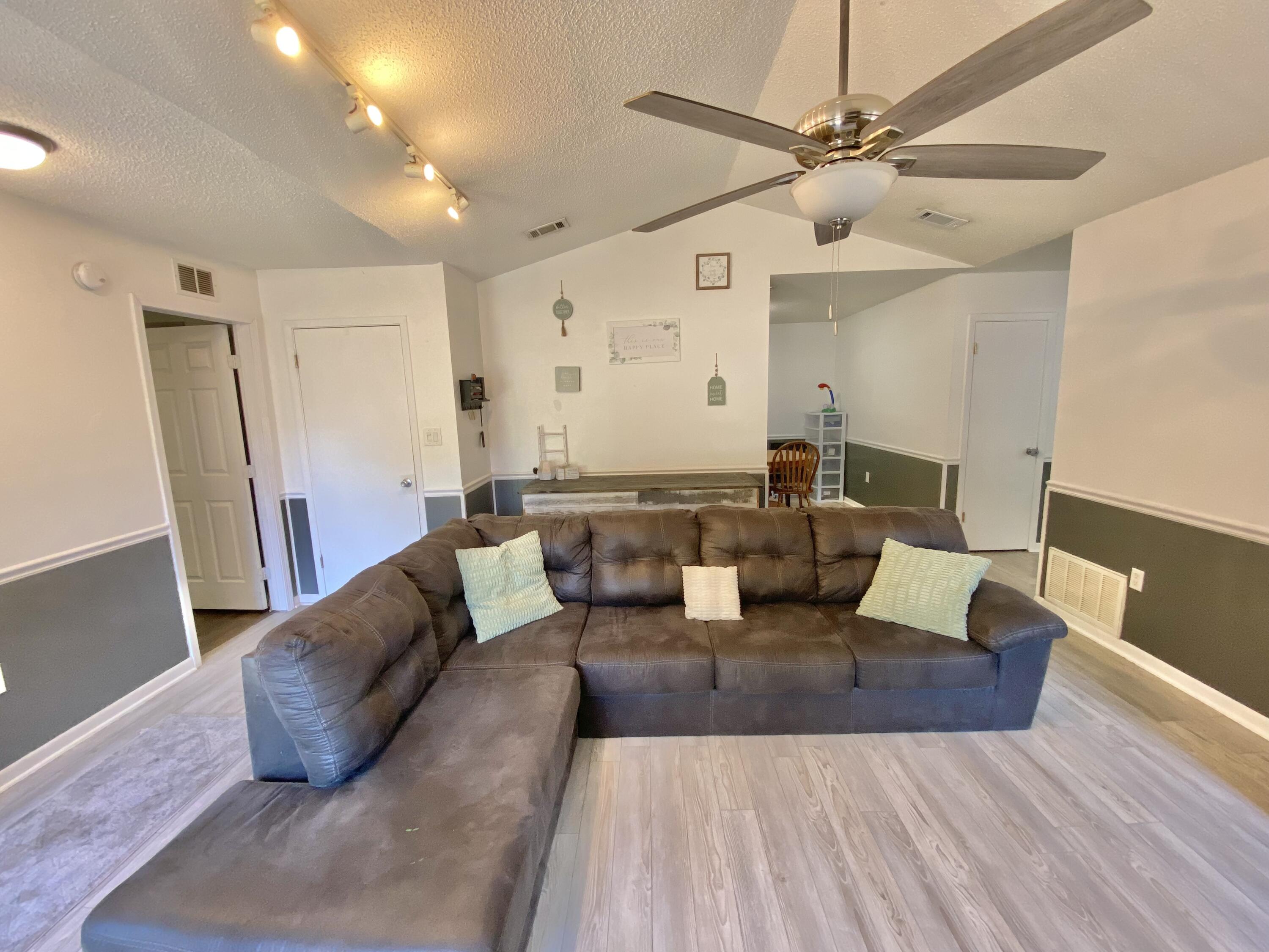 309 Springwood Circle Crestview, FL 32536 - Photo 10 of 44 a living room with furniture and a wooden floor