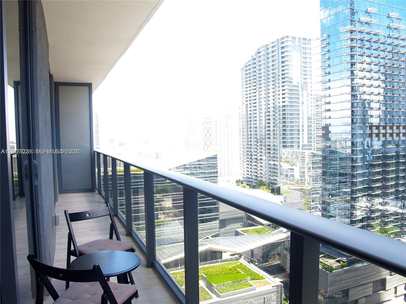 55 Southwest 9th Street, Unit 2502 Miami, FL 33130 - Photo 10 of 27 a view of balcony with wooden floor and outdoor seating