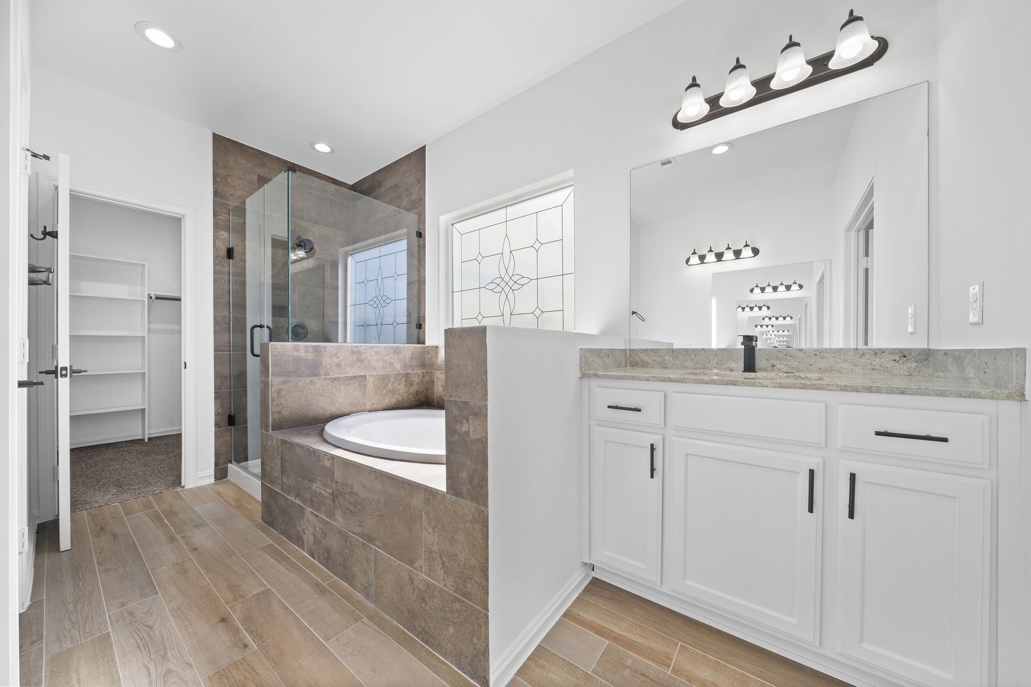 2019 Harlem Street Houston, TX 77020 - Photo 26 of 37 a spacious bathroom with a granite countertop sink a toilet a mirror and shower