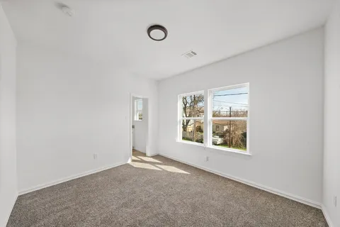 a view of an empty room and glass door