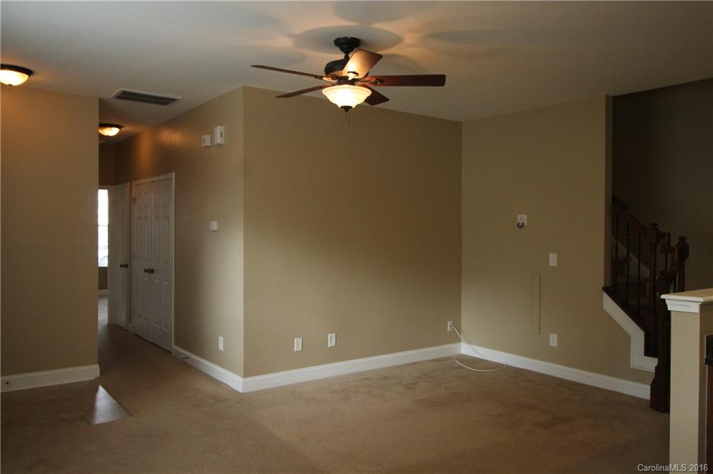 242 River Clay Road, Unit UNTI 202 Fort Mill, SC 29708 - Photo 6 of 18 wooden floor in an empty room with a fan