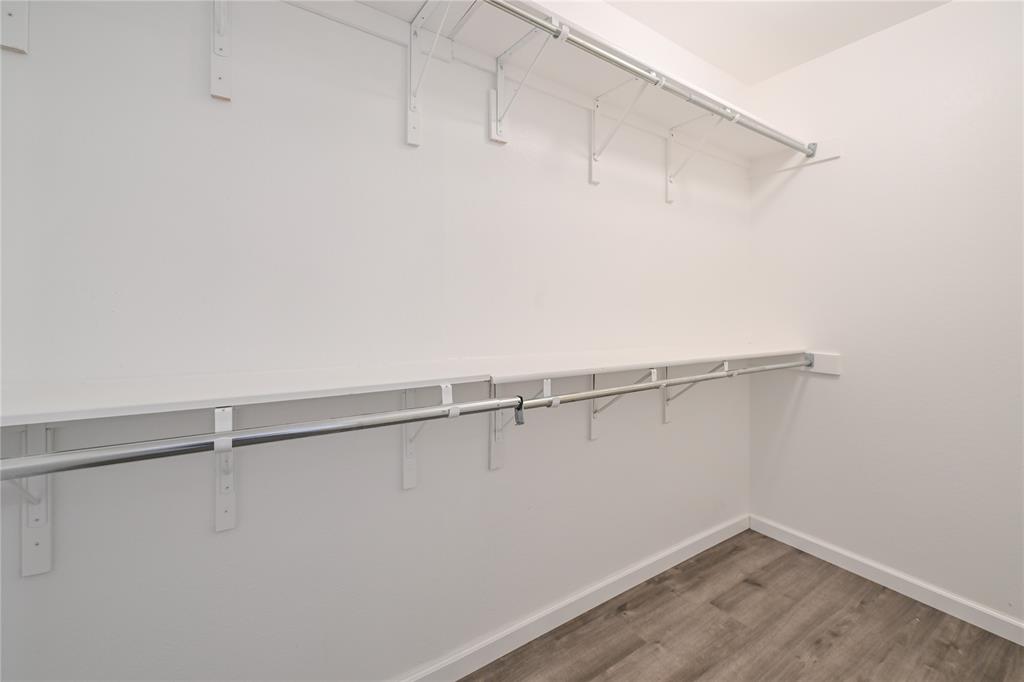 910 Rocking Spur Cove Pflugerville, TX 78660 - Photo 8 of 17 Functional closet featuring ample storage with shelving and hanging rods.