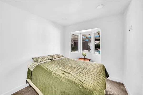 a bedroom with furniture and a window