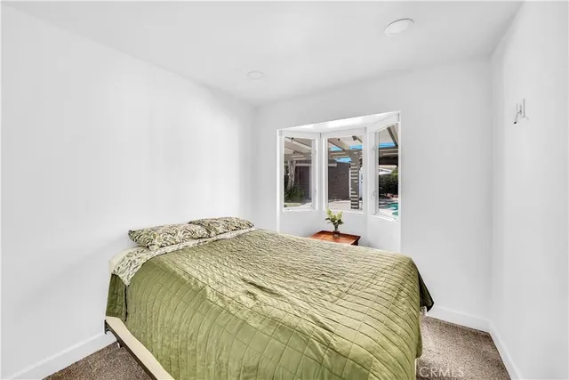 a bedroom with furniture and a window