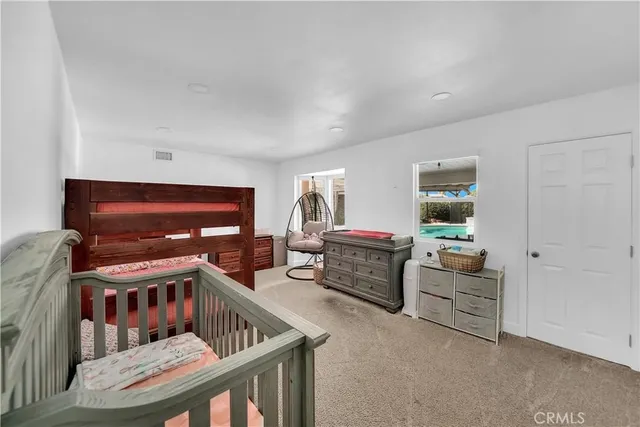 a bathroom with a granite countertop double vanity sink and a mirror