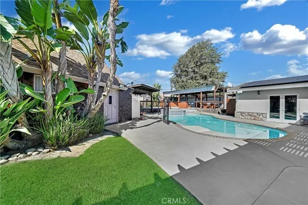 a swimming pool with outdoor seating yard and barbeque oven