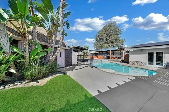 a swimming pool with outdoor seating yard and barbeque oven