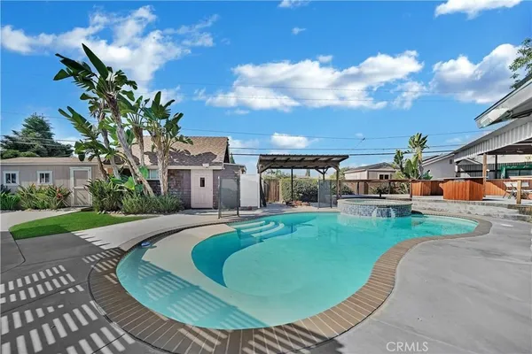 a view of a house with swimming pool and furniture