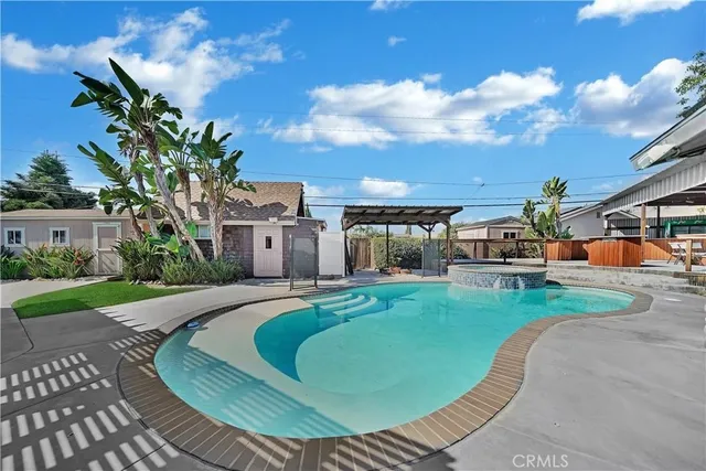 a view of a house with swimming pool and furniture
