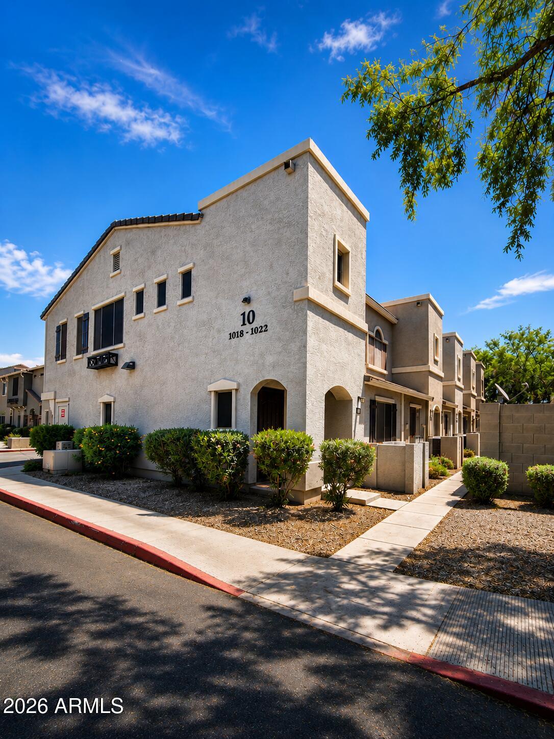 2150 West Alameda Road, Unit 1020 Phoenix, AZ 85085 - Photo 5 of 35 a front view of a house with a yard