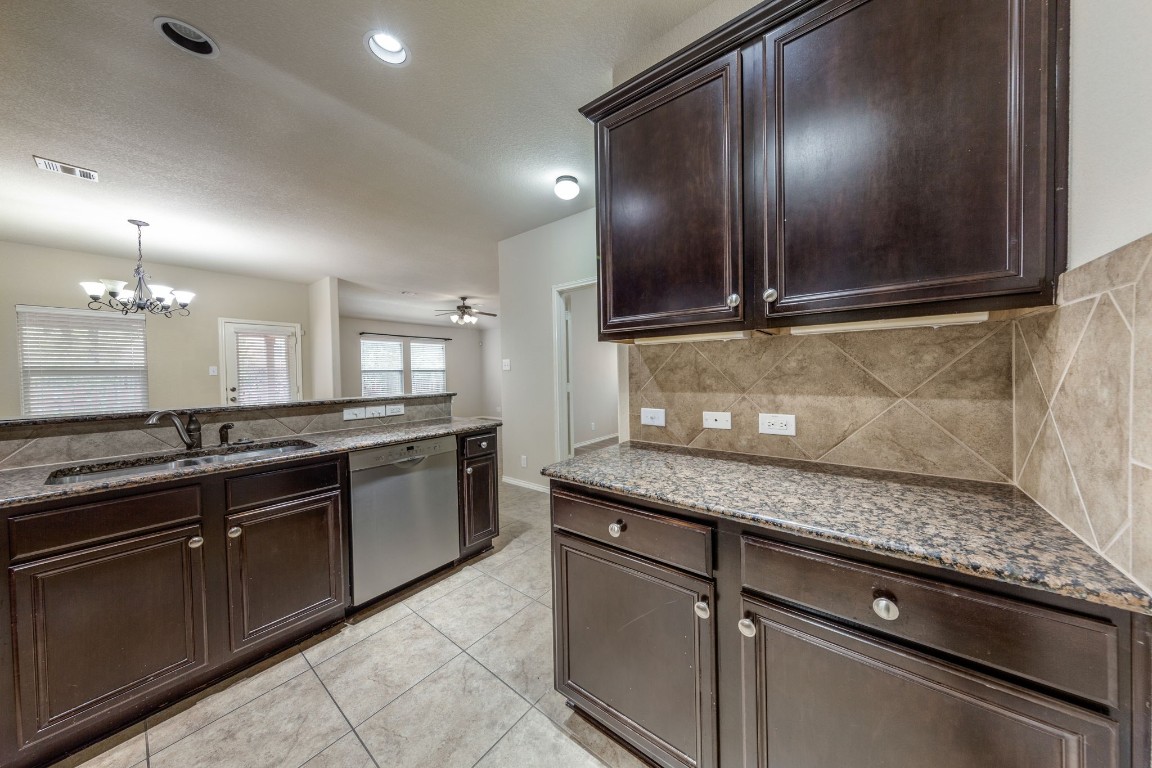 1811 Conn Creek Road Cedar Park, TX 78613 - Photo 7 of 33 a kitchen with granite countertop stainless steel appliances and sink