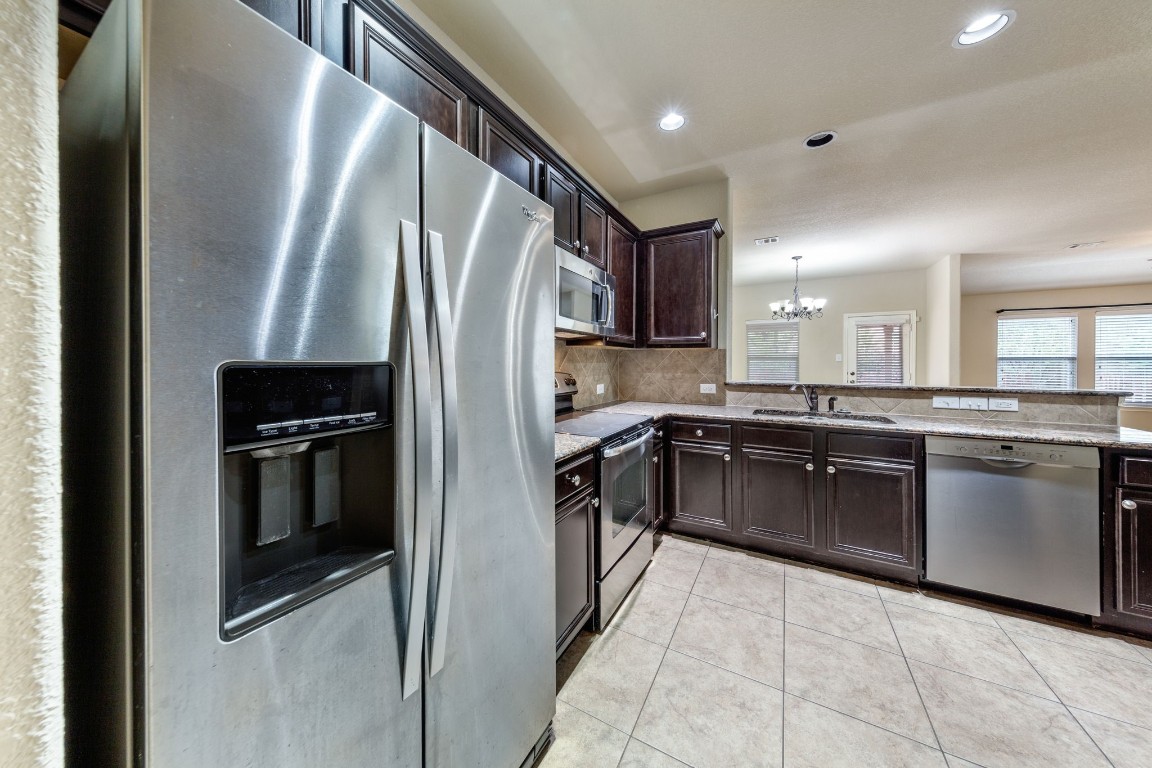 1811 Conn Creek Road Cedar Park, TX 78613 - Photo 9 of 33 a kitchen with a refrigerator sink and stove top oven