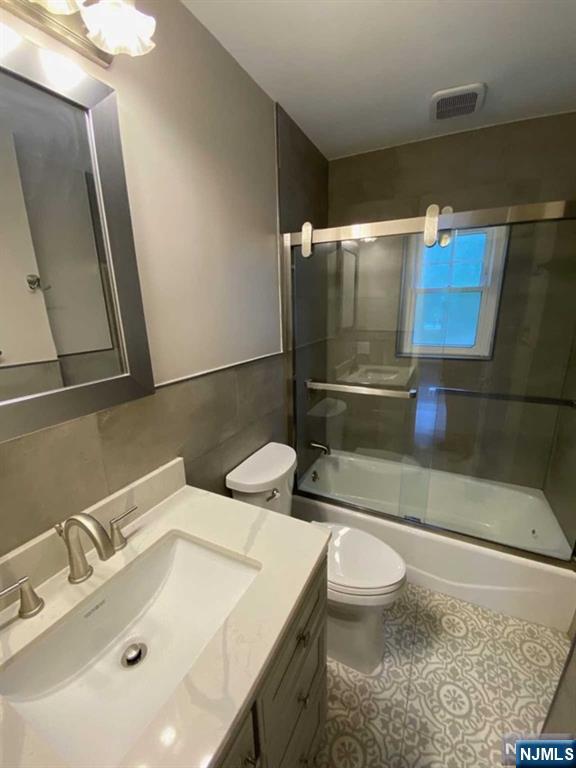 79 East Ridgewood Avenue Paramus, NJ 07652 - Photo 15 of 31 a bathroom with a sink a toilet and a mirror