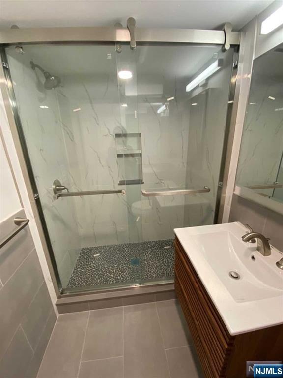 79 East Ridgewood Avenue Paramus, NJ 07652 - Photo 20 of 31 a bathroom with a sink a shower and a mirror