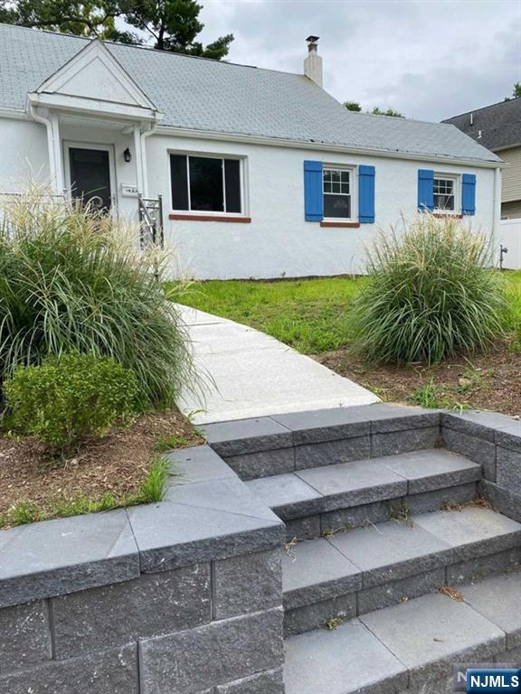 79 East Ridgewood Avenue Paramus, NJ 07652 - Photo 2 of 31 a front view of house with yard and green space
