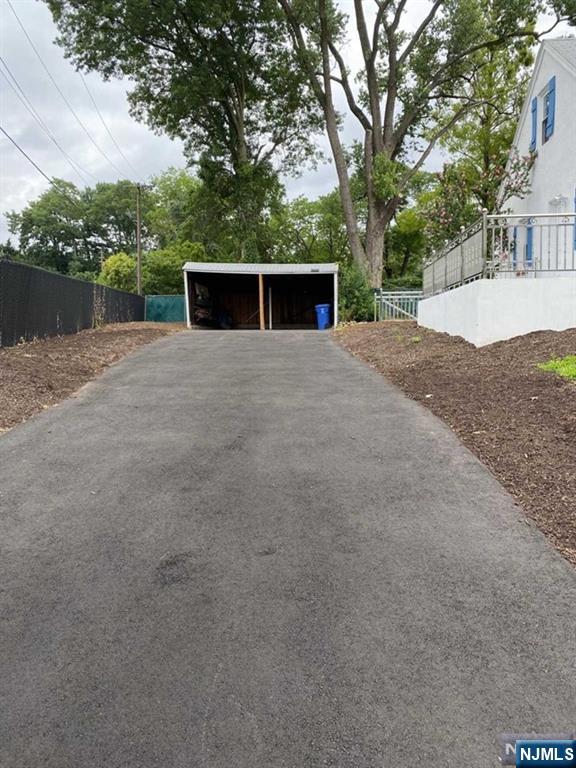 79 East Ridgewood Avenue Paramus, NJ 07652 - Photo 30 of 31 a view of a yard with a large tree