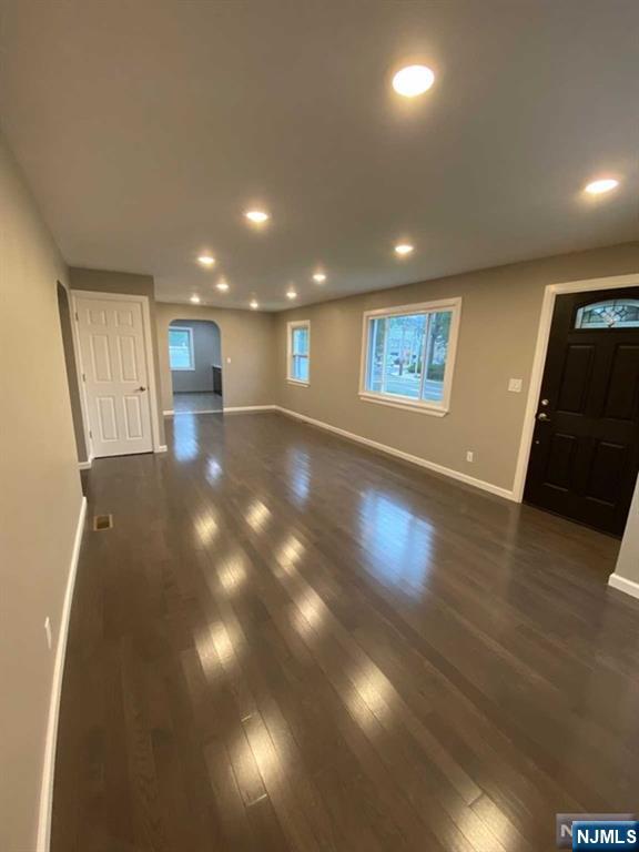 79 East Ridgewood Avenue Paramus, NJ 07652 - Photo 6 of 31 a view of an empty room with wooden floor and windows