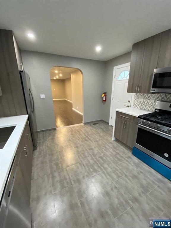79 East Ridgewood Avenue Paramus, NJ 07652 - Photo 9 of 31 a kitchen with stainless steel appliances a stove a sink and a refrigerator