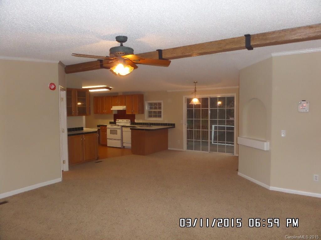 293 Sailwinds Road Mooresville, NC 28115 - Photo 2 of 15 a view of an empty room with kitchen and a window