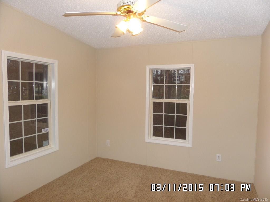 293 Sailwinds Road Mooresville, NC 28115 - Photo 11 of 15 an empty room with windows and fan
