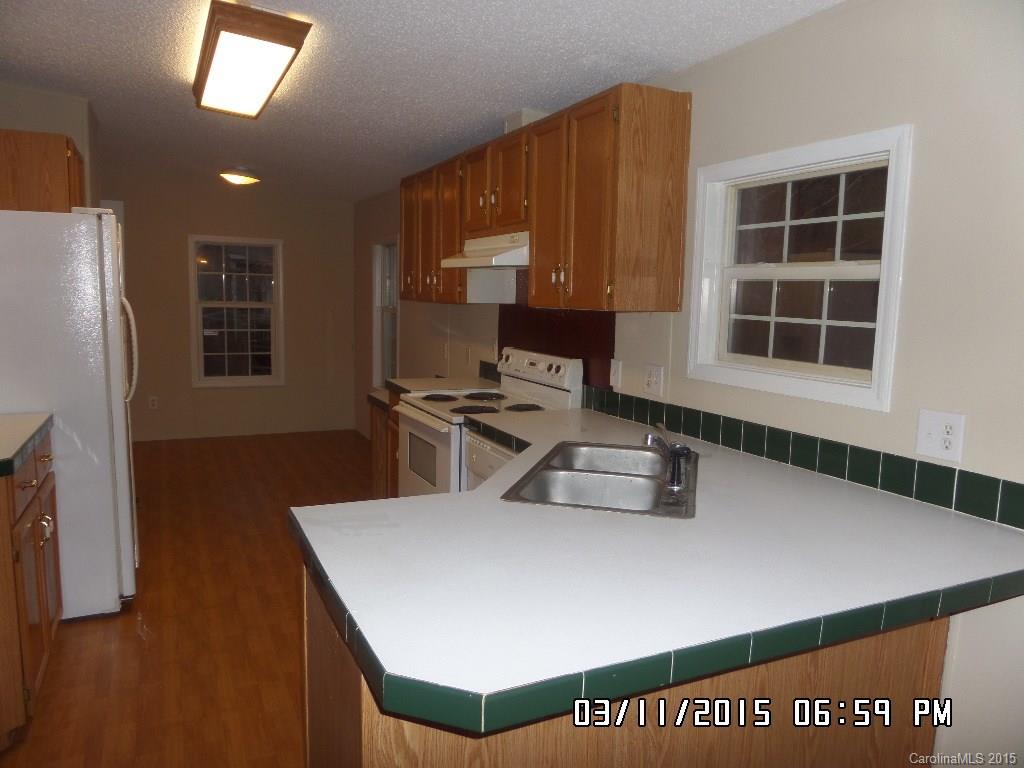 293 Sailwinds Road Mooresville, NC 28115 - Photo 6 of 15 a kitchen with a refrigerator a stove top oven a sink and a window
