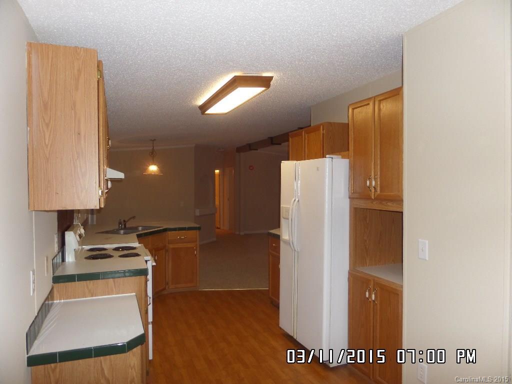 293 Sailwinds Road Mooresville, NC 28115 - Photo 7 of 15 a kitchen with a refrigerator and a stove