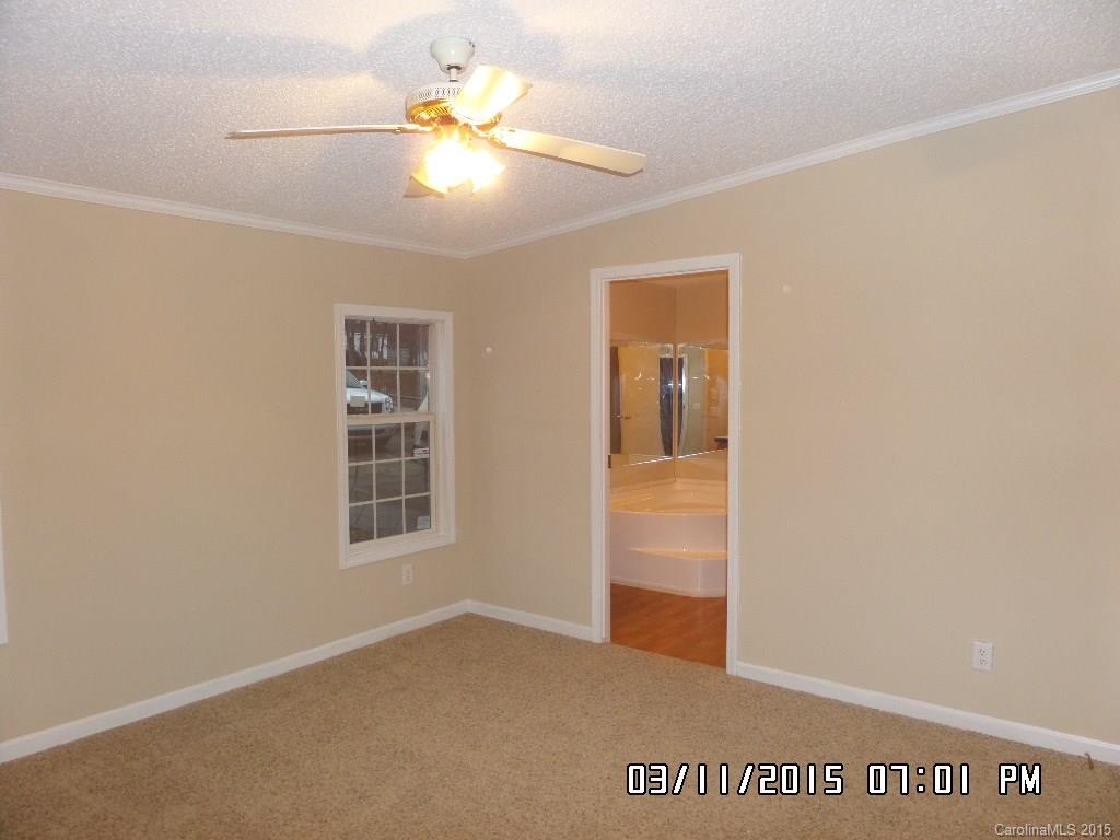 293 Sailwinds Road Mooresville, NC 28115 - Photo 8 of 15 an empty room with windows and fan
