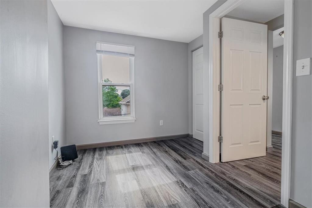 559 Boquet Street Carnegie, PA 15106 - Photo 11 of 20 a view of an empty room with wooden floor and a window