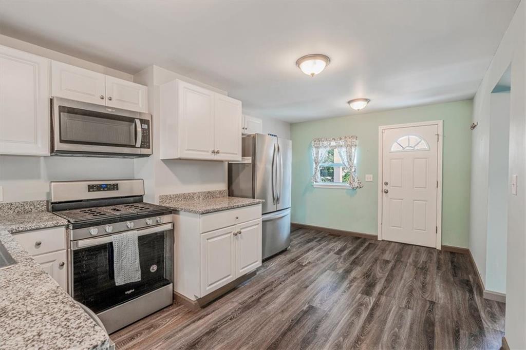 559 Boquet Street Carnegie, PA 15106 - Photo 4 of 20 a kitchen with granite countertop wooden floors and stainless steel appliances