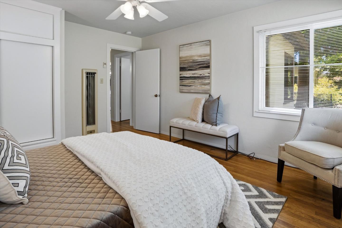 16899 Kennedy Road Los Gatos, CA 95032 - Photo 42 of 61 a bedroom with a bed a couch and a dresser with wooden floor
