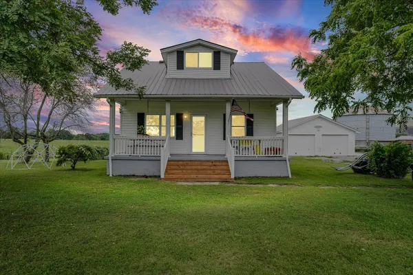 a front view of a house with a garden