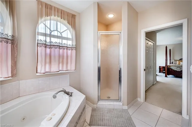 a bathroom with a tub and a view of bathroom