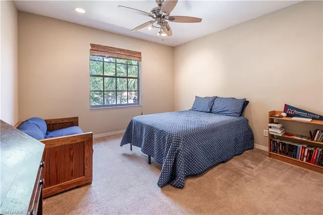 a bedroom with a bed and a book shelf