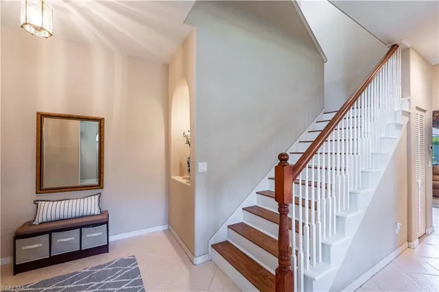 a view of staircase with wooden floor and a rug
