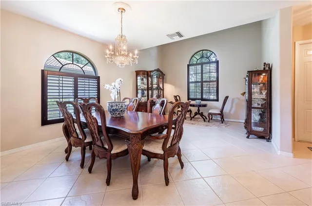a view of a dining room with furniture and chandelier