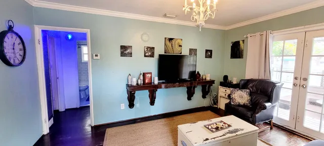 a living room with furniture and a flat screen tv