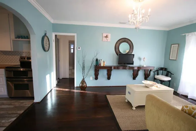 a living room with furniture and a wooden floor