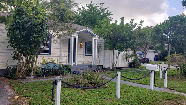a view of a chair and table in backyard of the house