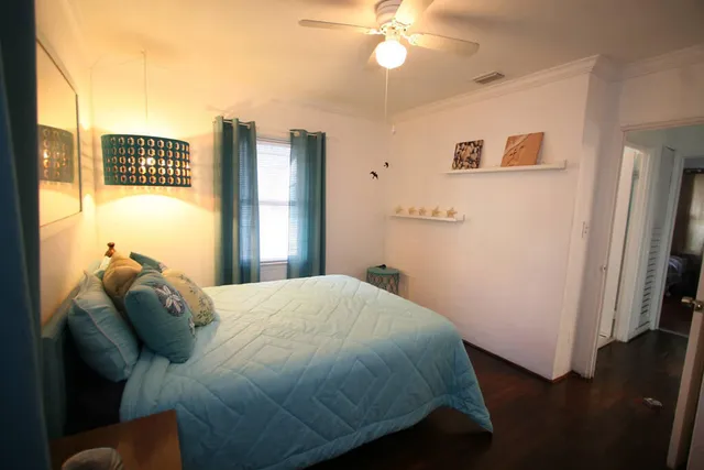 a bed sitting in a bedroom next to a window