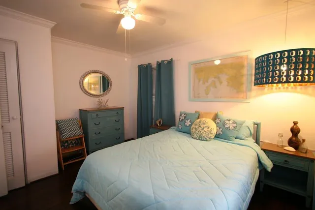 a bedroom with a bed and a chandelier