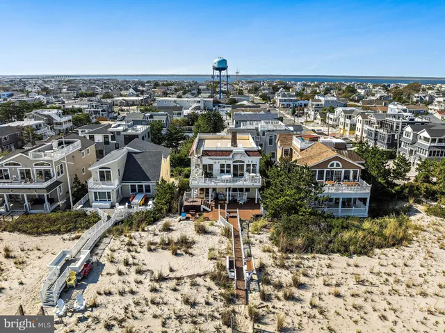 a living room with furniture kitchen view and a chandelier