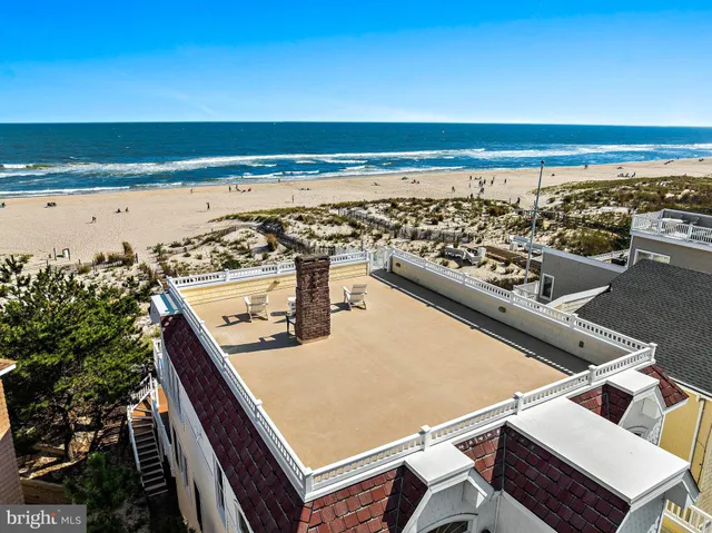 a kitchen with stainless steel appliances a stove a sink a center island and wooden floor