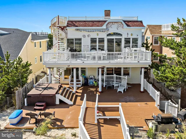 a kitchen with stainless steel appliances kitchen island granite countertop a table chairs and a refrigerator